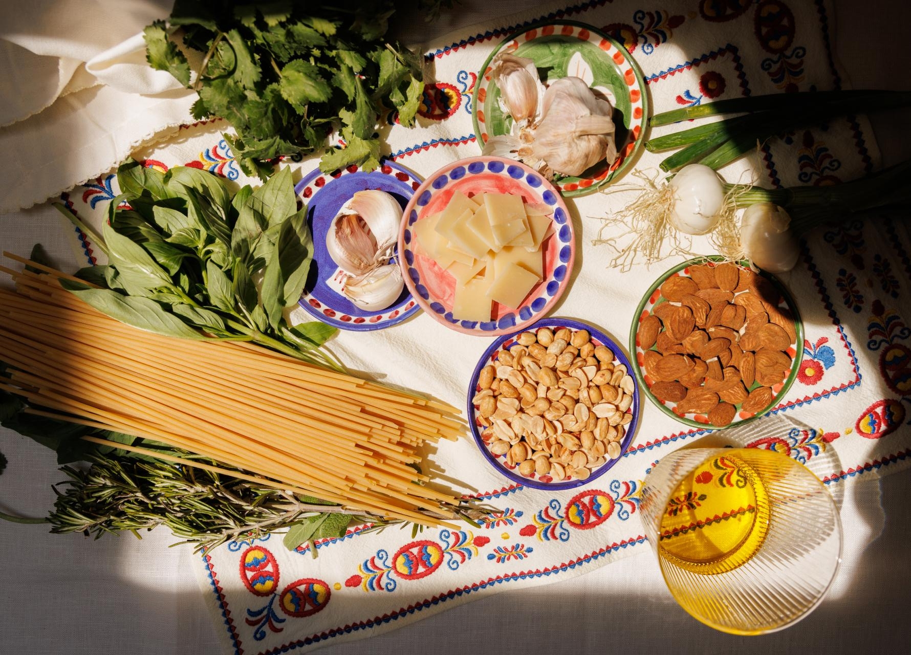 Trattoria v vaši kuhinji: Recept za popolne poletne špagete s pestom in hrustljavimi oreščki